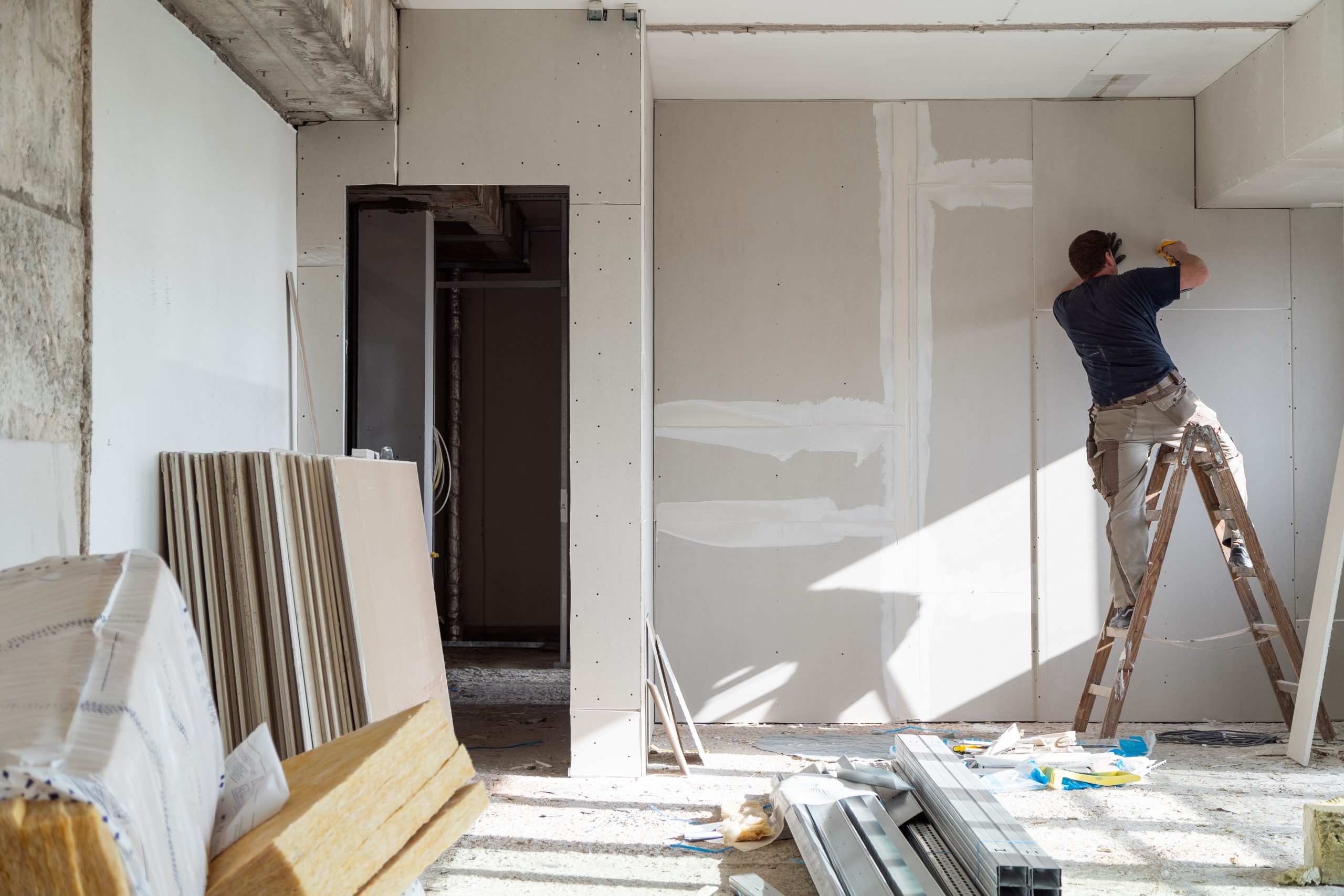 Renovation in progress with drywall installation, showing why self-storage is needed to protect belongings from construction dust and debris
